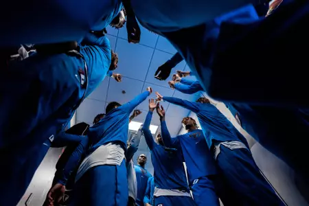men's basketball team huddle