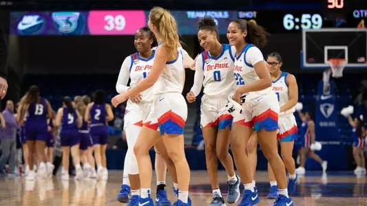 The Blue Demons celebrate Katlyn Gilbert's triple double in a 99-52 win over Stonehill.