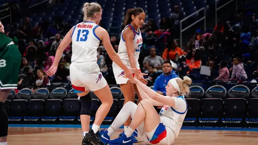 Maeve McErlane and Anaya Peoples help Brynn Masikewich up off the floor.