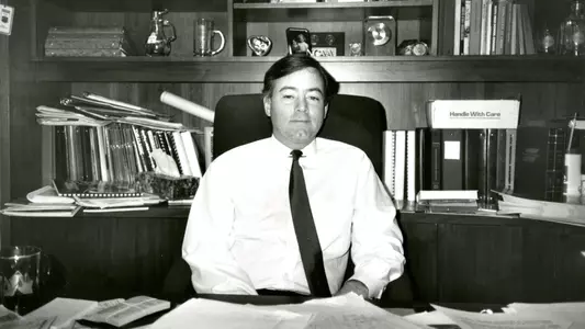 Bill Bradshaw sits at desk