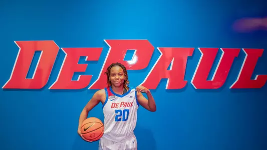 Shakara McCline holds a ball in front of a sign that reads DePaul