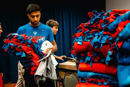DePaul student-athletes construct blankets to benefit St. Vincent de Paul Center.