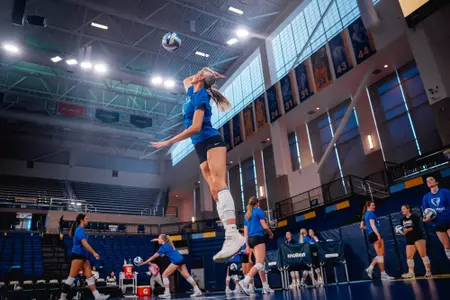 Meghan Scholz serving volleyball