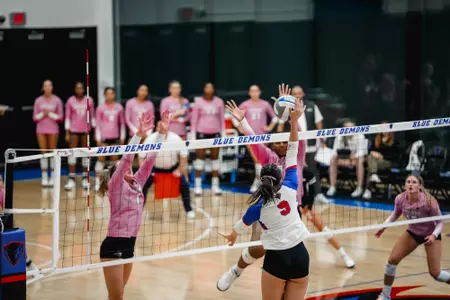 Luisa Juncu attacking volleyball at net