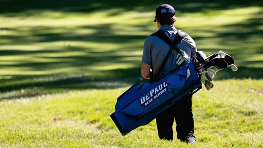 golfer carrying bag