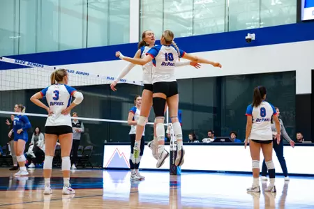 Katelynn Oxley and Meghan Scholz chest bump to celebrate a point