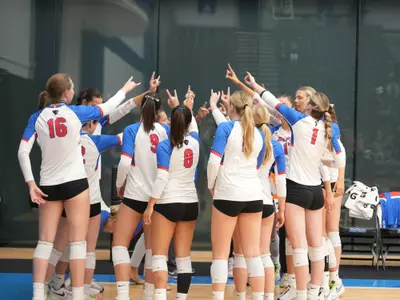 DePaul volleyball team huddles at McGrath-Phillips Arena