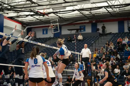 Jill Pressly attacks the volleyball at the net