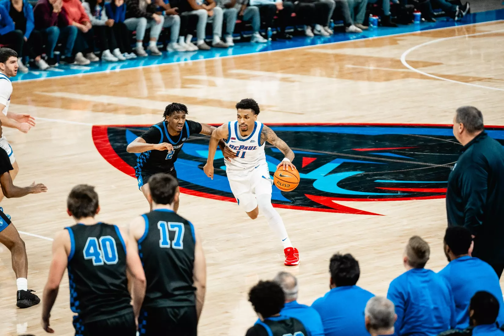 CJ Gunn dribbles the basketball