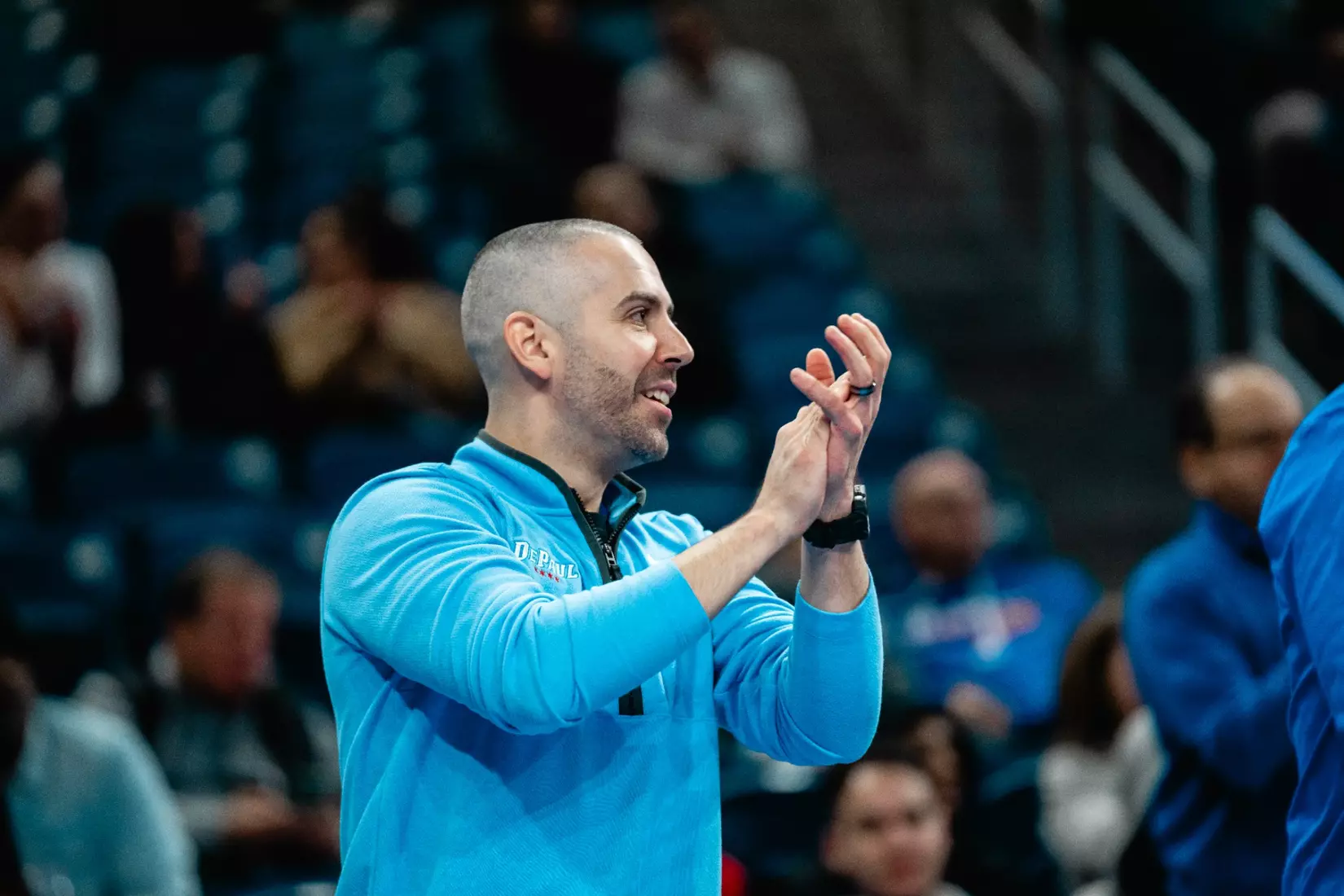 Coach claps from the sideline