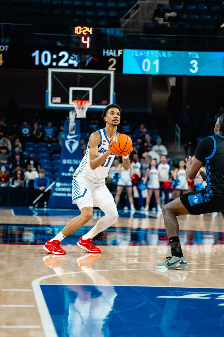 CJ Gunn takes a three-point shot