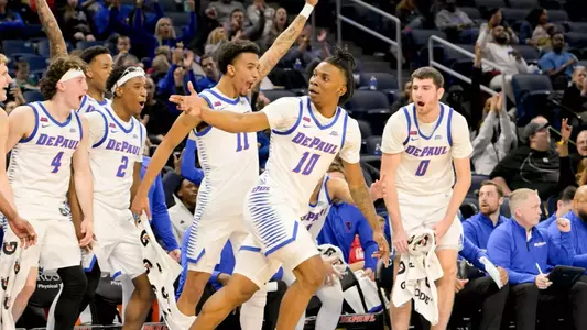 Chris Riddle, CJ Gunn, and team celebrate on the bench