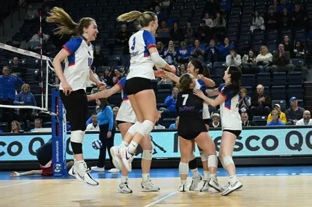 DePaul volleyball celebrating on the court