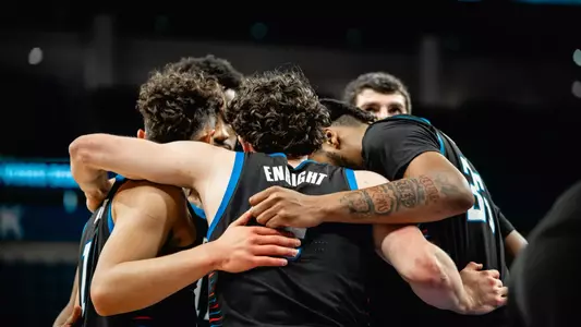 The team huddles prior to a free throw.