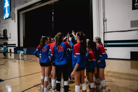 Volleyball team huddling