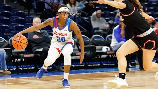 Sharkara McCline dribbles in front of defender.