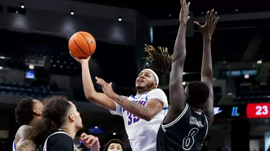 NJ Benson looks for a contested layup