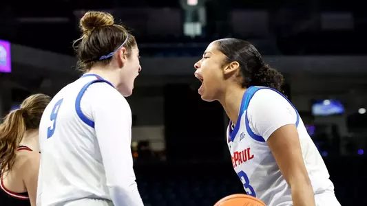 Meg Newman and Charlece Ohiaeri celebrate after made basket.