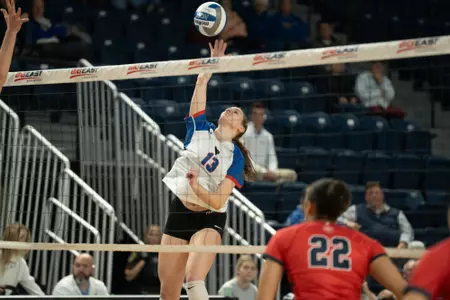 Aly Kindelberger hits the ball at the net