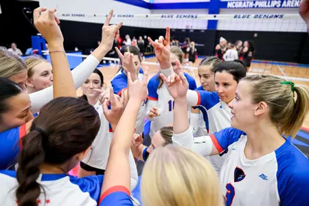 Volleyball team huddles