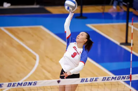 Luisa Juncu hitting volleyball at net