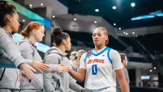 Taylor Johnson-Matthews high-fives teammates as she walks back to the bench.