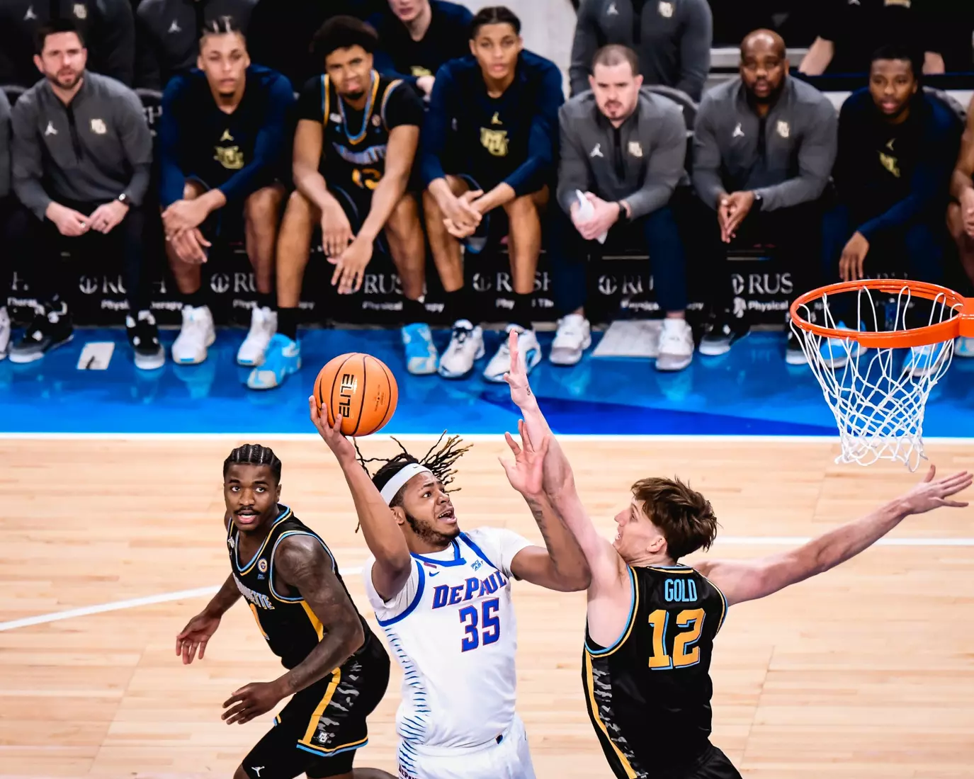 NJ Benson finishes a layup in traffic.