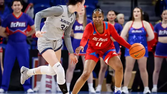 Sumer Lee dribbles against Xavier player.