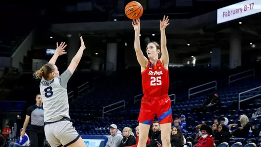 Kate Clarke attempts three-point shot from left wing.