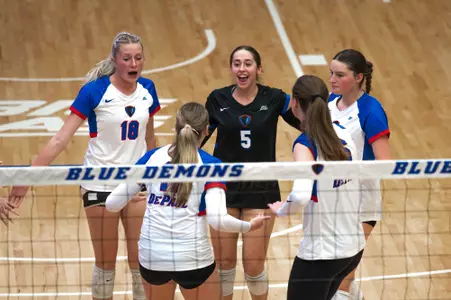 DePaul volleyball celebrates on the court after a point