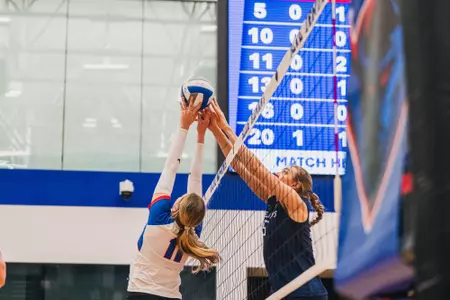 Amanda Saeger jousts with a Creighton player at the net