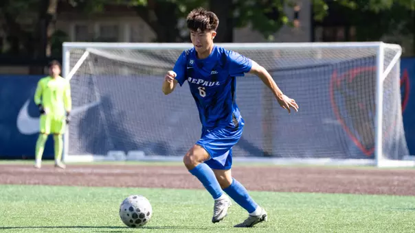 Joon Han dribbles down the field