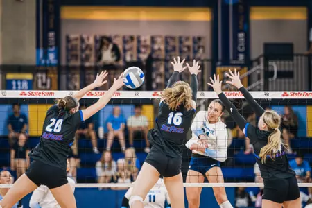 DePaul volleyball goes up for a block at the net