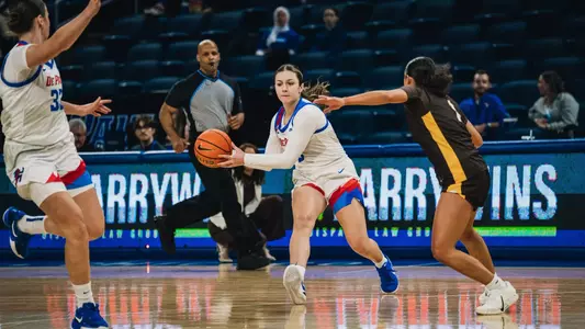 Freshman Gina Davorija feeds a dime into the cutting Blue Demon.