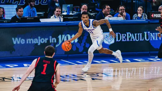 cj gunn dribbles the ball up the baseline