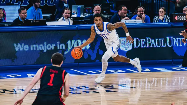 cj gunn dribbles the ball up the baseline