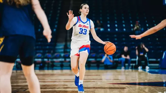 Kate Novik controlling the game before making a 3-point shot.