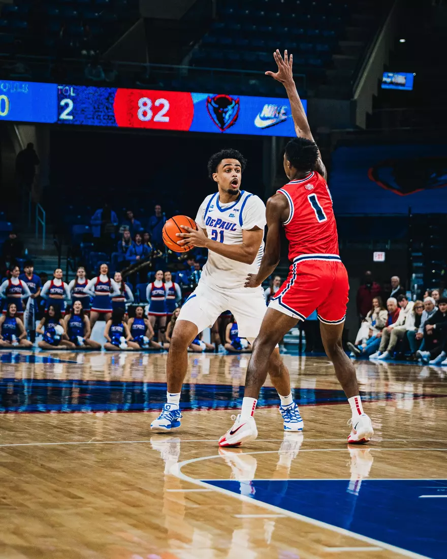 Theo Pierre-Justin is playing the ball in for a layup.