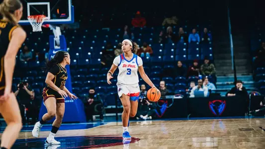 Alayna West takes the ball up the court.
