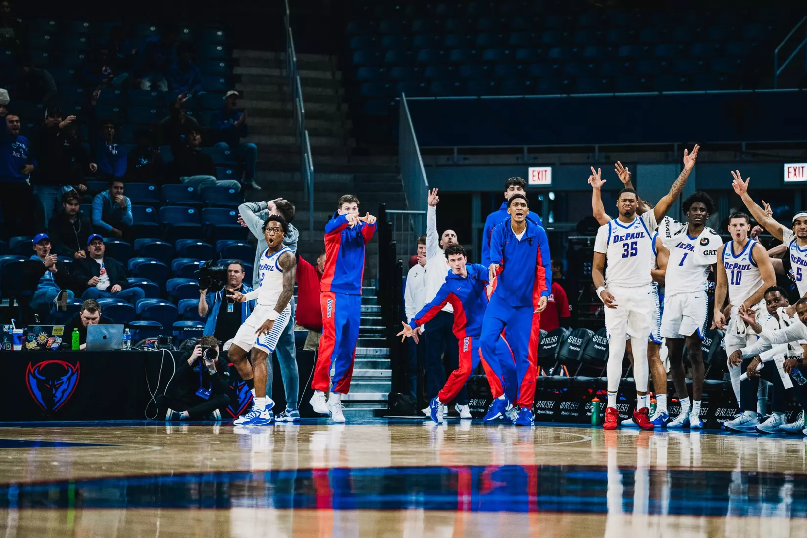 The DePaul bench celebrates a three pointer.