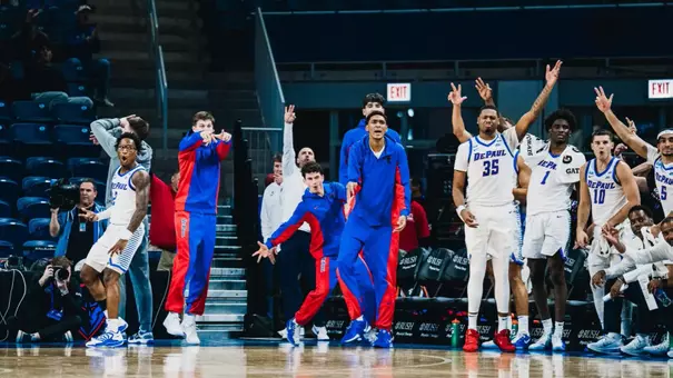 The DePaul bench celebrates a three pointer.