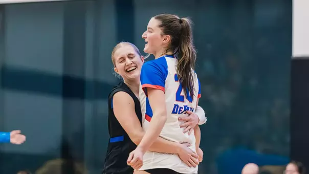 Abby Cahill hugs teammate Kendall Timme after a kill