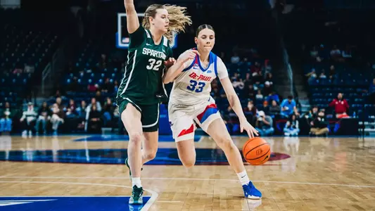 Kate Novik dribbles against a defender.