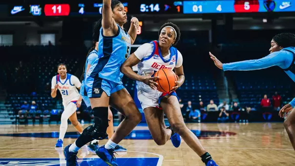 Michelle Ojo tries to drive through contact in the lane.