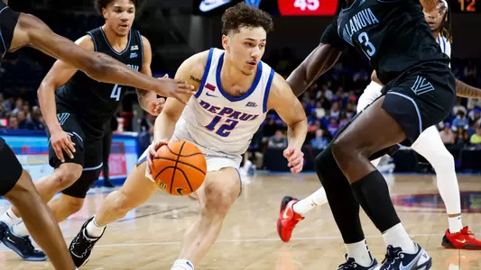 Jacob Meyer drives down court with his right hand.