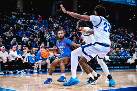 David Thomas looks up at the basket as he dribbles