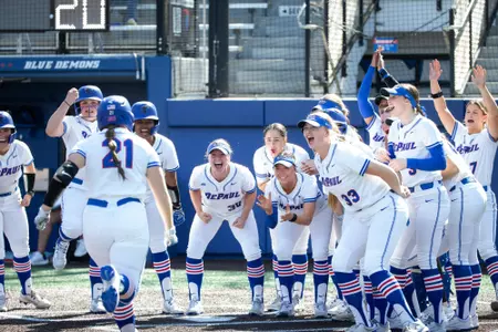 DePaul softball celebrates as Lydia Ettema comes across the plate