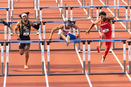 Darius Brown running in the 110M hurdles semi-finals.