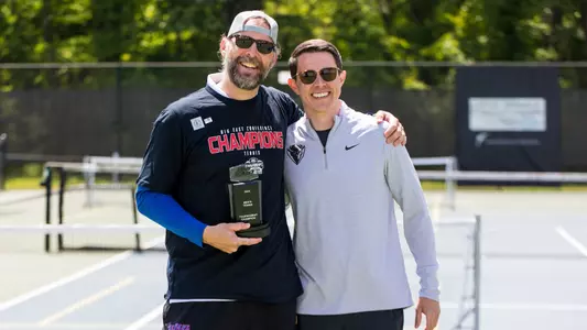 Matt Brothers & Taylor Stapleton pose for photo holding BIG EAST trophy