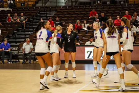 Eva Hurrle celebrates with her team on the court